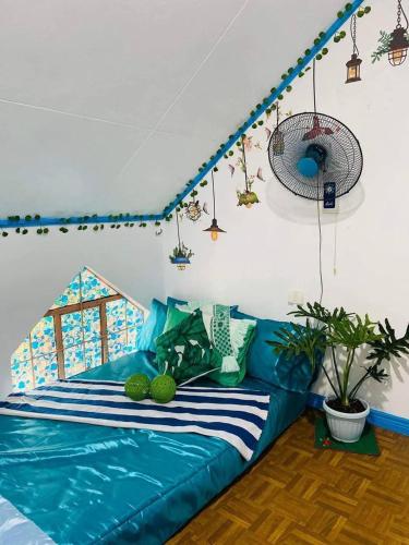 a blue couch sitting in a living room at Paula's Tagaytay Transient House in Tagaytay
