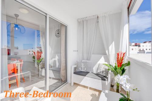 a white room with a balcony with a view of the ocean at BuenaVista Palmeras in Costa Adeje in Adeje