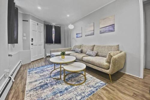 a living room with a couch and a table at Bright 2BR Apartment in Stamford in Stamford