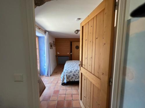 a hallway with a bedroom with a bed in it at Mas Lo Faix in Saint-Laurent-de-Cerdans