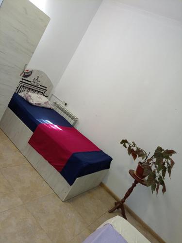 a bedroom with a bed with a colorful blanket at Old Center Yerevan in Yerevan