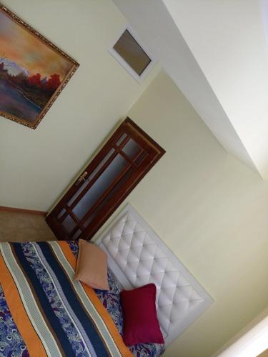 a bedroom with a bed and a painting on the wall at Old Center Yerevan in Yerevan
