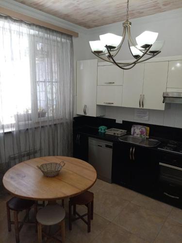 a kitchen with a wooden table and a dining room at Old Center Yerevan in Yerevan