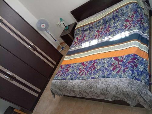a bed with a quilt on it in a room at Old Center Yerevan in Yerevan