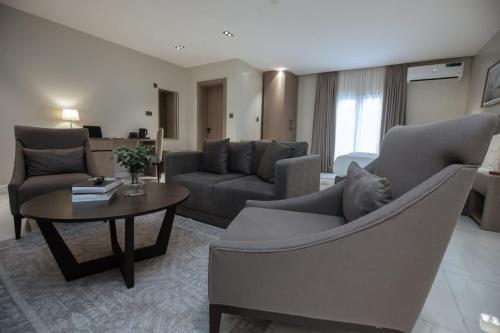 a living room with a couch and a table at Knightsbridge Hotel & Suites in Abuja