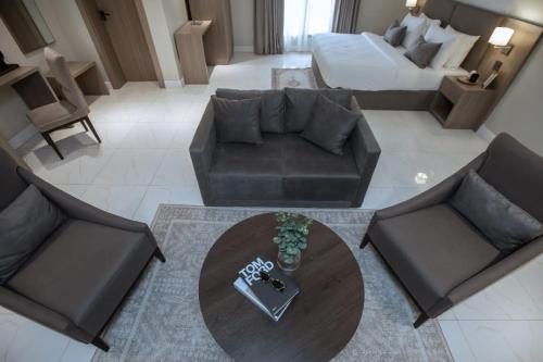 a living room with a couch and a table at Knightsbridge Hotel & Suites in Abuja