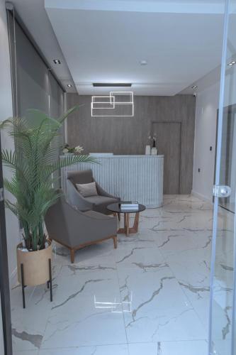 a living room with a couch and a table at Knightsbridge Hotel & Suites in Abuja