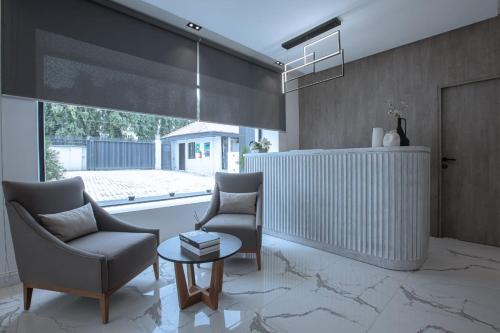 a living room with two chairs and a table at Knightsbridge Hotel & Suites in Abuja