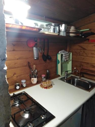 a kitchen counter with a stove and a sink at Raggio Di Sole in Alberobello