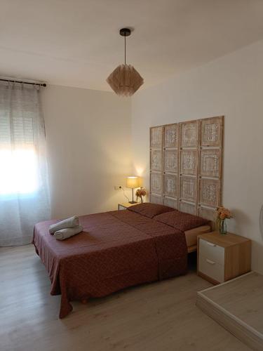 a bedroom with a large bed with a red bedspread at Holiday apartment in Puerto de Sagunto