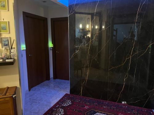 a room with a marble wall and a hallway at B&B Luxury in Lecce