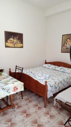 a bedroom with a bed and two chairs and a table at Home to rent-Casa vacanza-Shtepi pushimesh-KONDAJ in Orikum