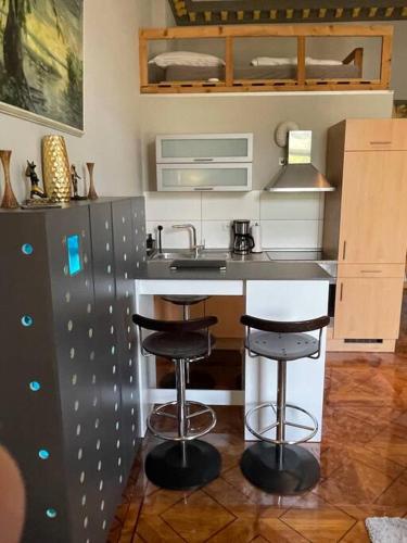 a kitchen with a counter and two bar stools at Studio 03 Apartment in Bremen in Bremen