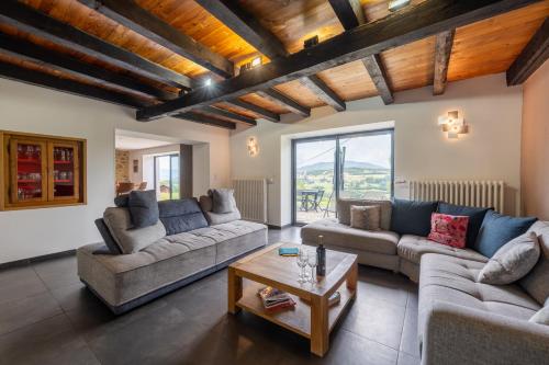 a living room with two couches and a coffee table at Domaine du Chypre in Cercier