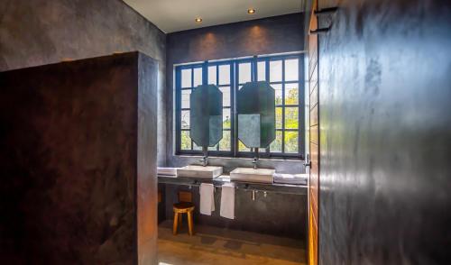a bathroom with two sinks and two mirrors at Turquoise Tulum Hotel in Tulum