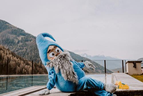 a mascot sitting on top of a building at Hotel Bergschlössl in Luson