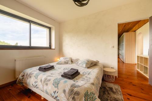 a bedroom with a bed with two towels on it at Domaine du Chypre in Cercier