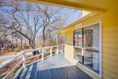 a front porch of a yellow house with a window at Spacious Texas Getaway half Mi to Lake Texoma! in Pottsboro