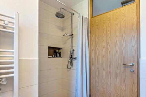 a shower with a glass door in a bathroom at Willhelm - Hauff in Engen