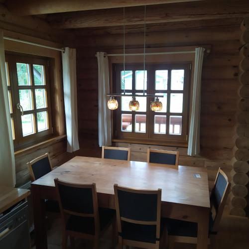 a dining room with a wooden table and chairs at Jan in Steendam