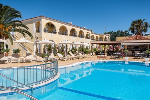 a large swimming pool in front of a building at Konstantina Apartments in Kavos