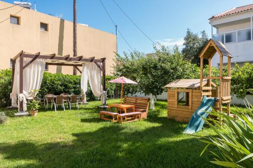 a backyard with a gazebo and a house at Konstantina Apartments in Kavos