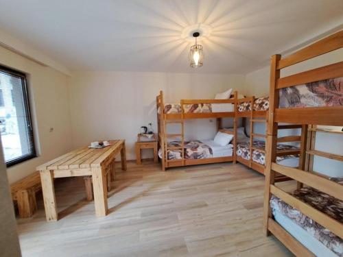 a room with two bunk beds and a table at Galasha in Mestia