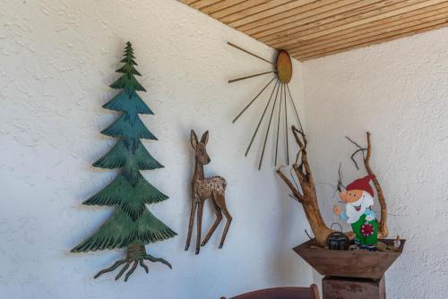 a wall with christmas decorations and a christmas tree on it at Haus Isele in Urberg