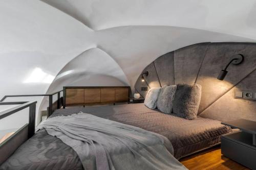 a bedroom with a large bed in a room at Cozy Carmelite apartment in Vilnius