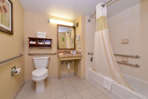 a bathroom with a toilet and a shower and a sink at Hampton Inn Chicago-Carol Stream in Carol Stream