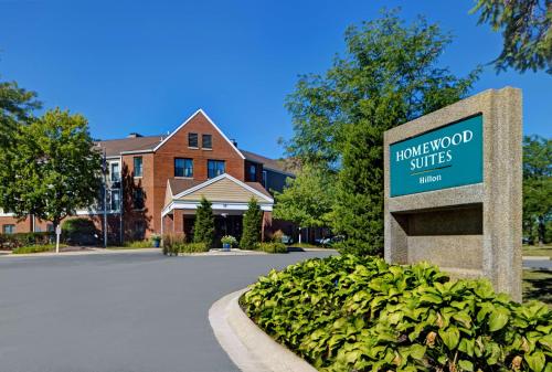 a sign in front of a building with a house at Homewood Suites by Hilton Chicago-Lincolnshire in Lincolnshire
