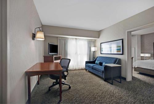 a hotel room with a desk and a bed at Homewood Suites by Hilton Chicago-Lincolnshire in Lincolnshire