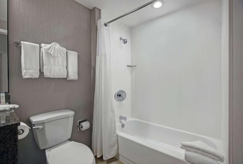 a bathroom with a white toilet and a shower at Homewood Suites by Hilton Chicago-Lincolnshire in Lincolnshire