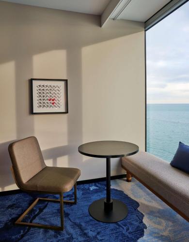 a room with a couch and a table and a chair at Sable At Navy Pier Chicago, Curio Collection By Hilton in Chicago