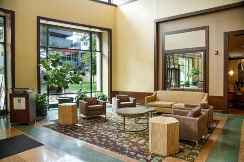 a lobby with couches and chairs and a table at Embassy Suites by Hilton Chicago O'Hare Rosemont in Rosemont