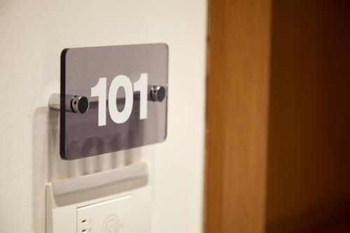 a lightswitch with the number on a wall at Glass House - Smart Rooms & Parking in Lecce