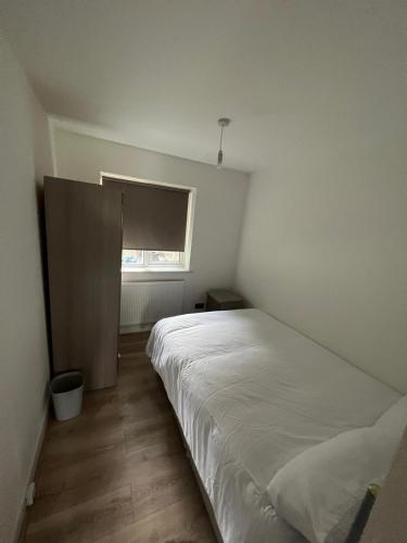 a bedroom with a white bed and a window at Flat 1 Hobart Lodge in Hendon