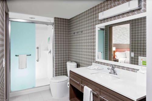 a bathroom with a sink and a shower and a mirror at Home2 Suites By Hilton North Charleston University Blvd in Charleston
