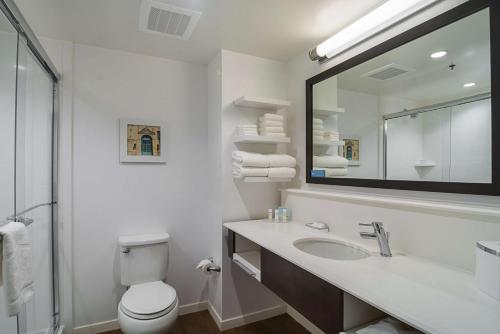a bathroom with a sink and a toilet and a mirror at Hampton Inn Chicago North-Loyola Station, Il in Chicago