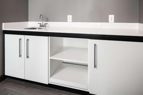 a bathroom with a sink and a white cabinet at Hampton Inn Iowa City/Coralville in Coralville