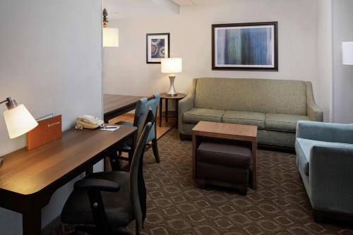a living room with a couch and a table and chairs at Homewood Suites by Hilton Cleveland-Solon in Solon