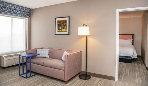a living room with a couch and a bed at Hampton Inn Cleveland-Solon in Solon