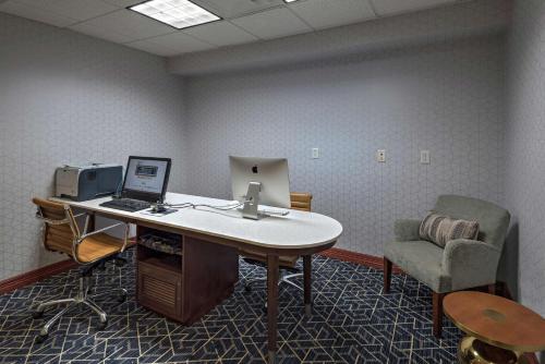 an office with a desk with a laptop and a chair at Homewood Suites by Hilton College Station in College Station