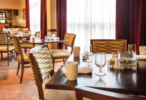 a dining room with a table and chairs with wine glasses at DoubleTree by Hilton Charlotte Airport in Charlotte