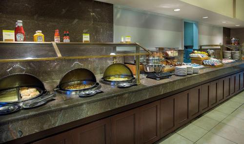 a buffet line in a restaurant with food at DoubleTree by Hilton Charlotte Airport in Charlotte
