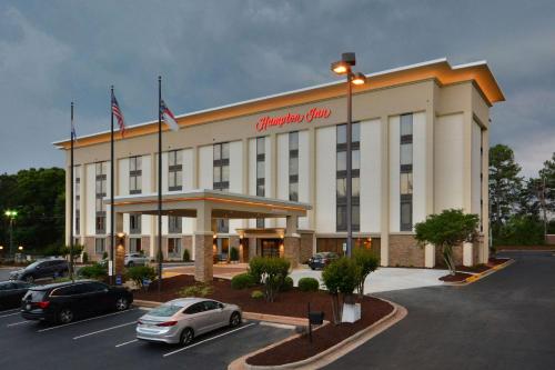 a hotel with cars parked in a parking lot at Hampton Inn Charlotte North Lake Norman in Cornelius