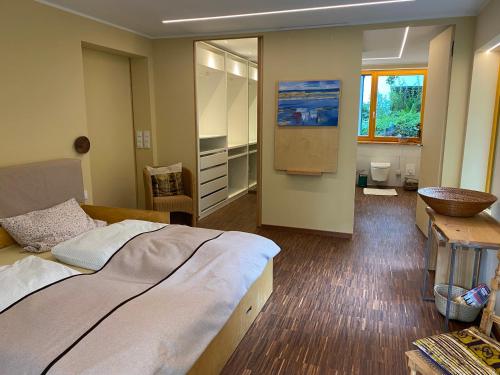 a bedroom with a large bed and a bathroom at KatharinaS in Pirmasens