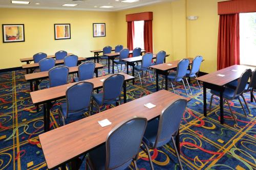 a classroom with desks and chairs in a room with yellow walls at Hampton Inn & Suites Huntersville in Huntersville