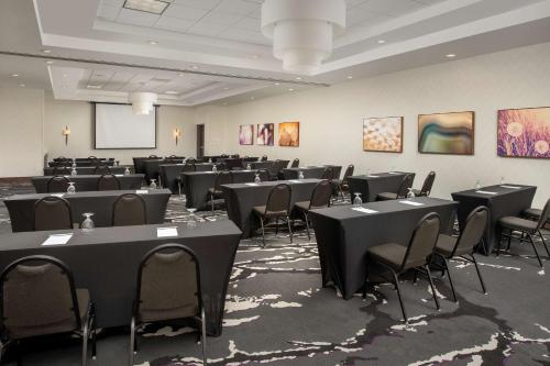 a large room with tables and chairs in it at Hilton Garden Inn Charlotte Airport in Charlotte