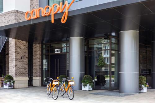 a group of bikes parked outside of a building at Canopy By Hilton Charlotte SouthPark in Charlotte